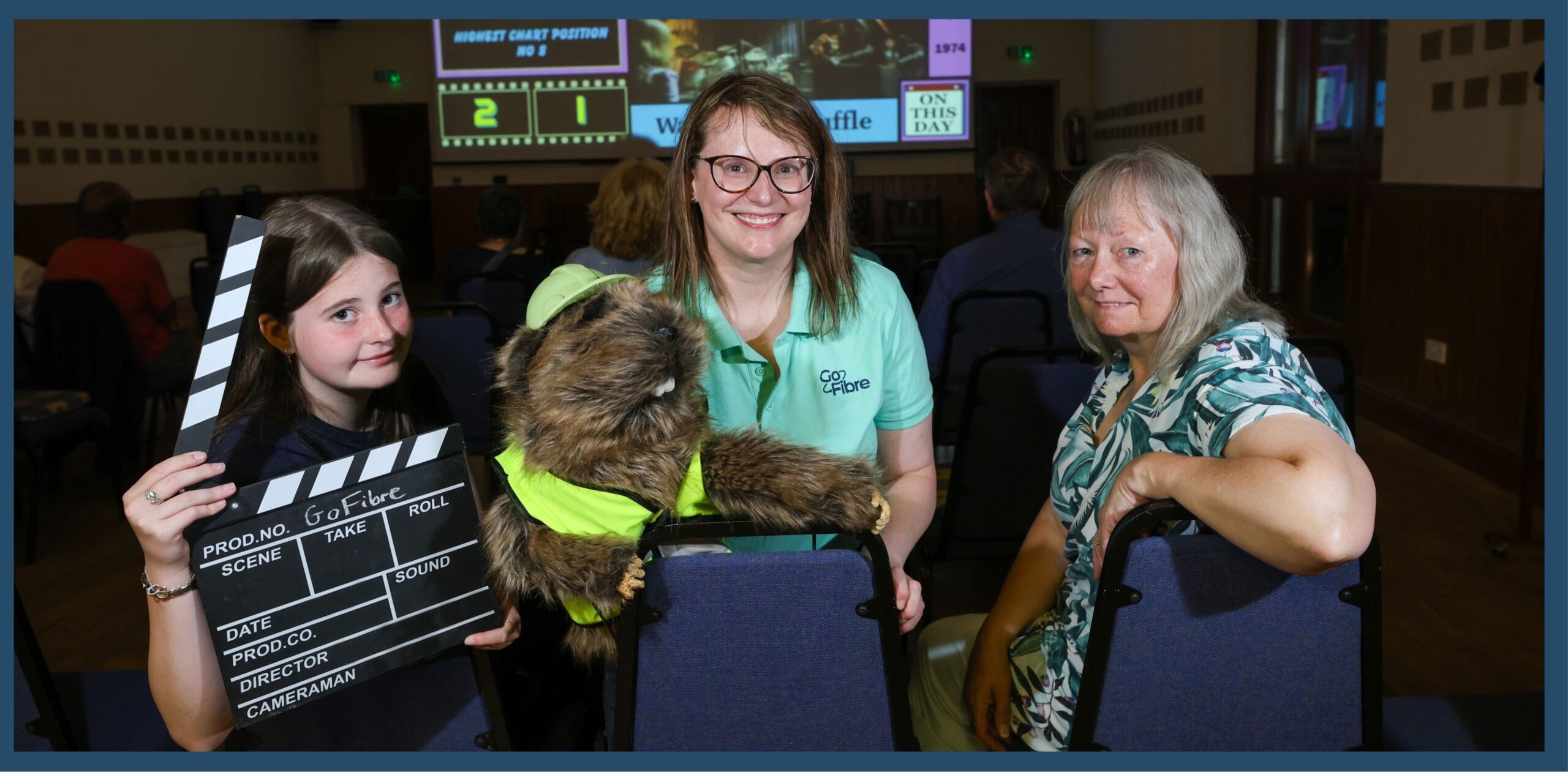 Ivy Swanston, Mickleton Cinema Club Member, and Digby the Gopher, with Claire Munro, GoFibre representative, and Sue Kelly, Mickleton Cinema Club Member at Mickleton Cinema Club