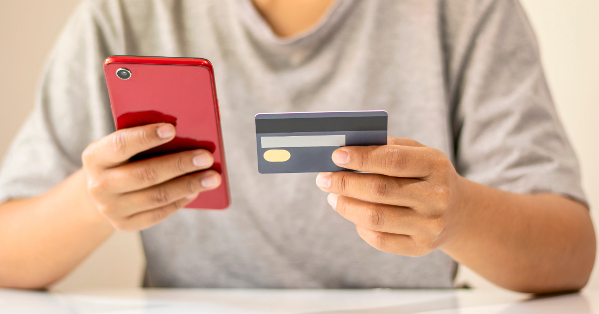 Person, mobile phone, credit card